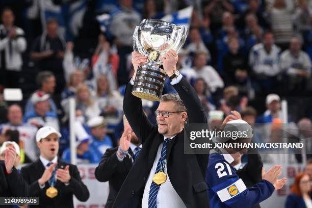 Finland's head coach Jukka Jalonen celebrates with the trophy after the IIHF Ice Hockey World Championships final match between Finland and Canada in...