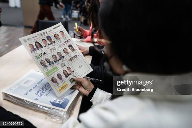 Polling official holds a ballot at a polling location during the first-round presidential election in Bogota, Colombia, on Sunday, May 29, 2022....