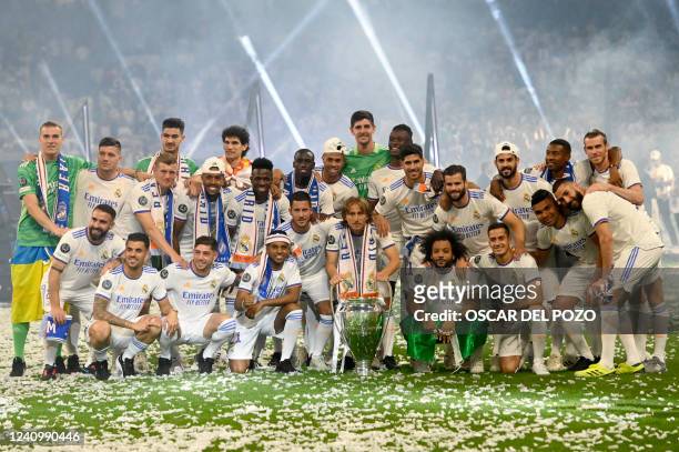 Real Madrid's players pose with their trophy during the club's celebration of their 14th European Cup at the Santiago Bernabeu stadium in Madrid on...
