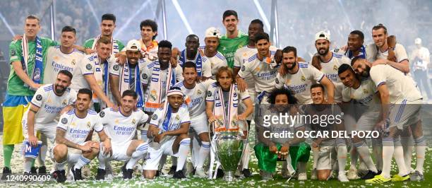 Real Madrid's players pose with their trophy during the club's celebration of their 14th European Cup at the Santiago Bernabeu stadium in Madrid on...