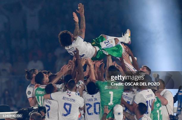 Real Madrid's Brazilian defender Marcelo is tossed in the air by teammates during the club's celebration of their 14th European Cup at the Santiago...
