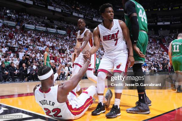 Bam Adebayo and Kyle Lowry help up Jimmy Butler of the Miami Heat during Game 7 of the 2022 NBA Playoffs Eastern Conference Finals on May 29, 2022 at...