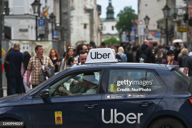 An Uber car is waiting for customers on Grodzka Street in the center of Krakow. Krakow, one of Europe's top tourist destinations, listed UNESCO World...