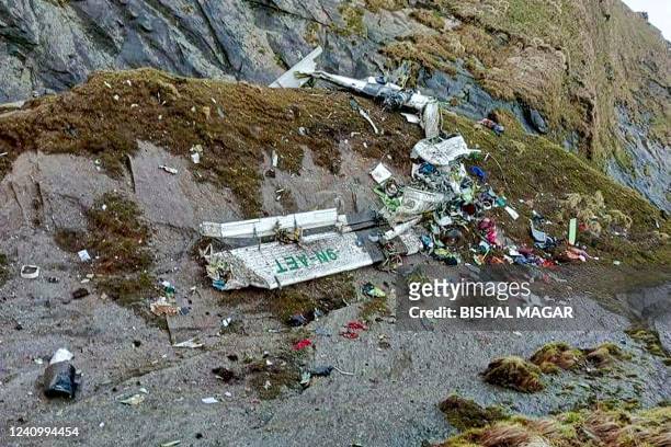 Graphic content / TOPSHOT - The wreckage of a Twin Otter aircraft, operated by Nepali carrier Tara Air, lay on a mountainside in Mustang on May 30 a...
