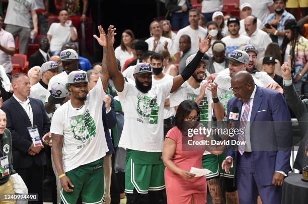 Marcus Smart and Jaylen Brown of the Boston Celtics celebrate while ESPN Sideline Reporter, Lisa Salters talks to former Boston Celtics player Cedric...