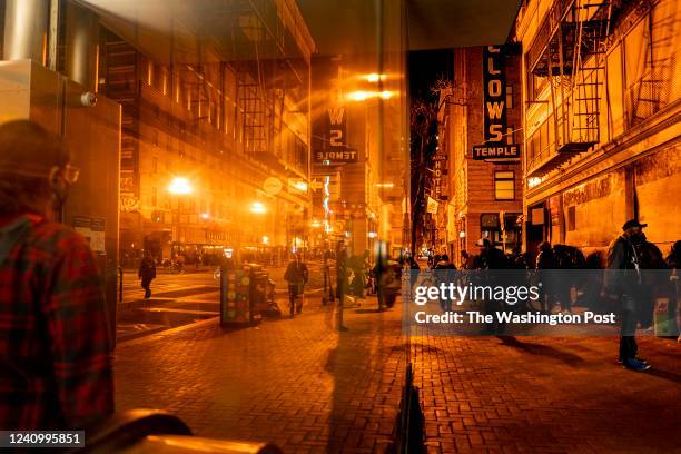 Riders emerge from the Civic Center BART stop as people hangout on a street corner with heavy drug use and drug sales in the Tenderloin neighborhood...