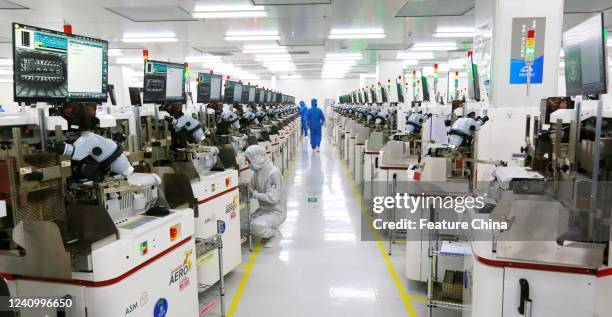 People work at a manufacturer of semiconductors in Suining in southwest China's Sichuan province Tuesday, May 24, 2022.