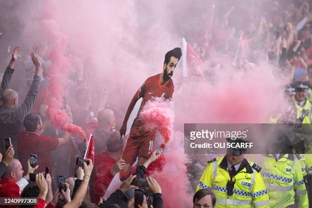 Liverpool's supporters hold a cardboard cutout of Liverpool's Egyptian midfielder Mohamed Salah as players parade through the streets of Liverpool in...