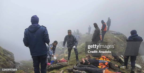 Armed Police Force, Rescue team carry the bodies of the passengers from the crash site of Tara Air at the hilly area of Thasang village of Mustang...