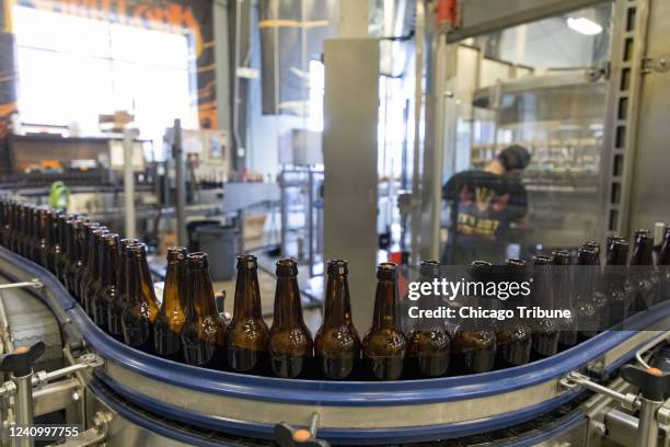 Bottles are ready on a line at Three Floyds Brewing in Munster, Indiana, on Thursday, May 19, 2022.