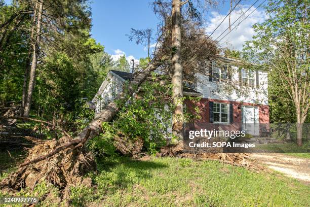 Tree leaning on the rooftop of a damaged house is seen after the storm. The storm on the 21st of May in the province of Quebec left a trail of...