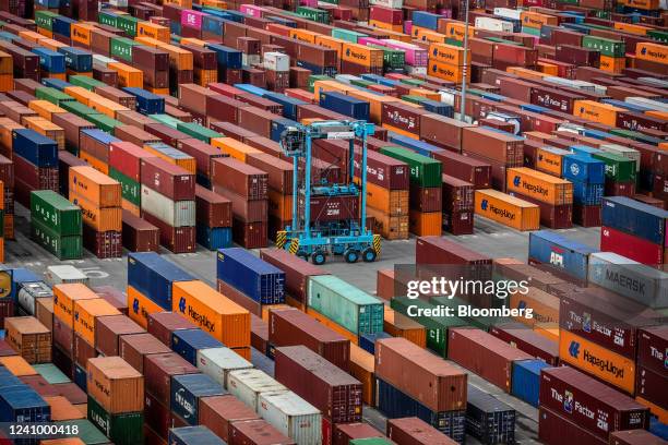 Crane maneuvers a shipping container at the Muelle Sur terminal, operated by APM Terminals, at the Port of Barcelona in Barcelona, Spain, on Friday,...