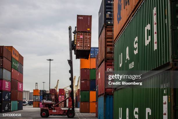 Reach stacker lifts a shipping container at the Muelle Sur terminal, operated by APM Terminals, at the Port of Barcelona in Barcelona, Spain, on...