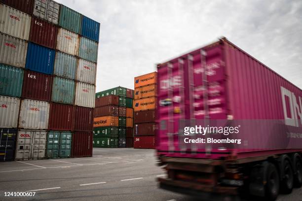 Truck passes shipping containers stacked at the Muelle Sur terminal, operated by APM Terminals, at the Port of Barcelona in Barcelona, Spain, on...