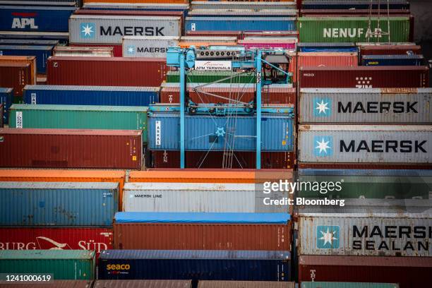 Crane maneuvers a shipping container at the Muelle Sur terminal, operated by APM Terminals, at the Port of Barcelona in Barcelona, Spain, on Friday,...