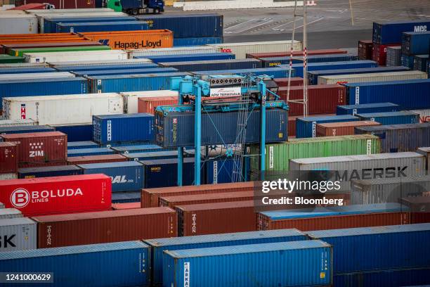 Crane maneuvers a shipping container at the Muelle Sur terminal, operated by APM Terminals, at the Port of Barcelona in Barcelona, Spain, on Friday,...