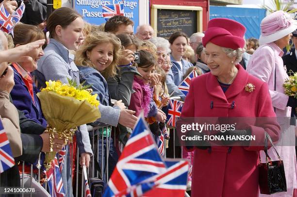 Queen Elizabeth II greets wellwishers at Falmouth harbour, 01 May 2002, on the first day of her nationwide Golden Jubilee tour which is starting with...