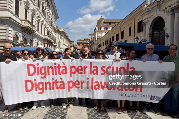 Teachers and workers with a banner saying: dignity for schools, dignity for workers ,join the protest and school strike against the government's DL36...