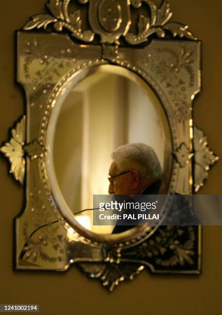 Noble Peace Prize Laureate Dr Henry Kissinger is seen reflected in a mirror as he speaks during a seminar in Mumbai on November 19, 2008. Kissinger,...