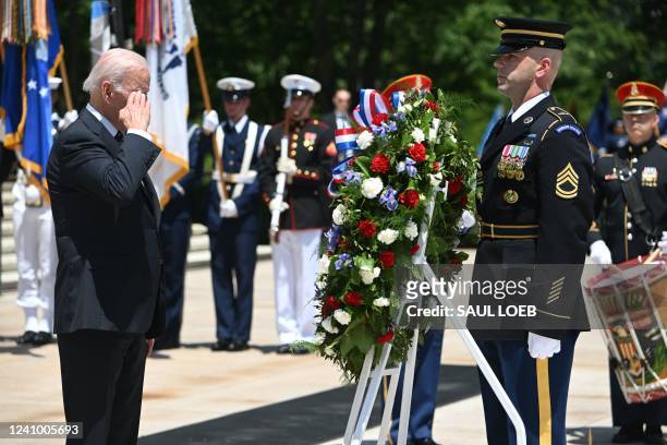 President Joe Biden salutes during a wreath laying ceremony at the Tomb of the Unknown Soldier in honor of Memorial Day at Arlington National...