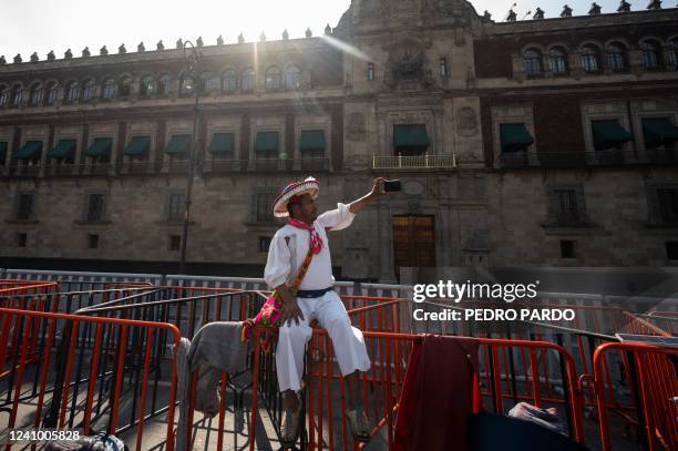 Wixarika indigenous man takes a selfie picture as members of his community offer a press conference in front of the Palacio Nacional after meeting...