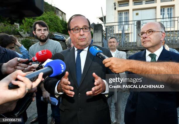 French former President Francois Hollande of French socialist party , flanked by former Prime minister Bernard Cazeneuve speaks to media during a...