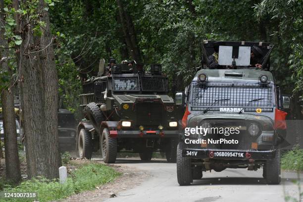 Indian army vehicles move near the site of gun-battle in south Kashmir's Pulwama on May 30, 2022.Two militants of Jaish-e-Muhammad militant outfit...