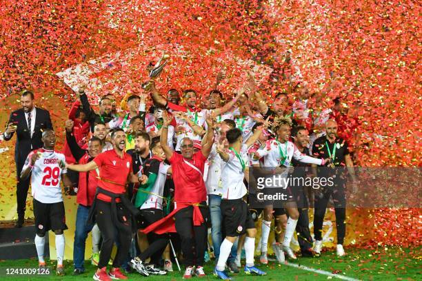 Wydad's players celebrate with the trophy after winning the CAF Champions League Semi-Final between Egypt's al-Ahly and Morocco's Wydad AC at Stade...