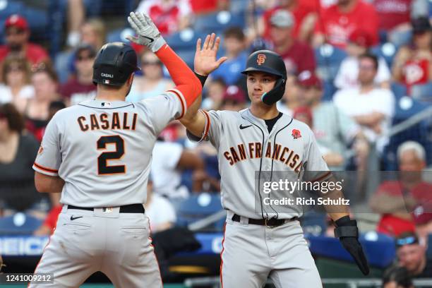 Curt Casali of the San Francisco Giants celebrates his two-run home with Stuart Fairchild in the 10th inning against the Philadelphia Phillies at...