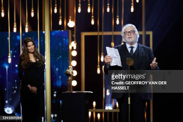 French actor Jacques Weber, flanked by French model and actress Laetitia Casta , speaks as he receives the Honor award during the ceremony for the...