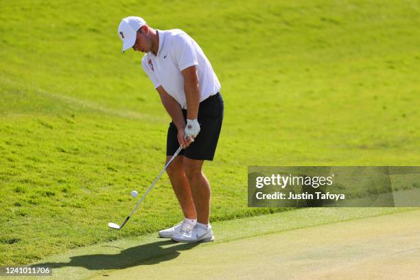 Jonas Baumgartner of the Oklahoma State Cowboys chips on the green during the Division I Mens Golf Championship held at the Grayhawk Golf Club on May...