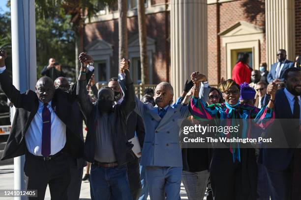 Attorney Benjamin Crump, Marcus Arbery, Reverend Al Sharpton and Wanda Cooper-Jones react outside the Glynn County Courthouse after jurors found the...