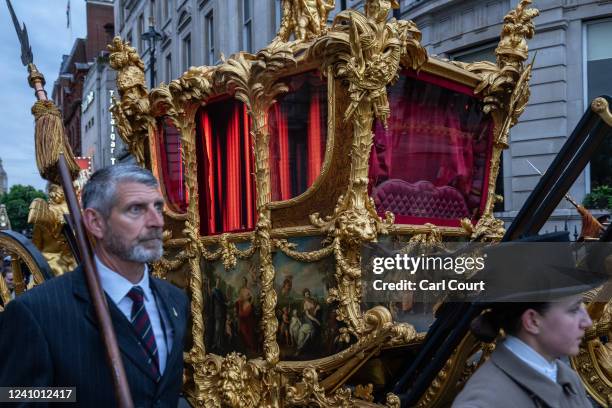 The Gold State Coach which carried HM Queen Elizabeth II at her Coronation is seen here featuring digitally displayed illuminated curtains during a...