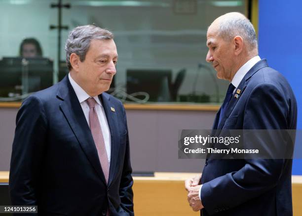 Italian Prime Minister Mario Draghi is talking with the outgoing Slovenian Prime Minister Janez Jansa prior an EU Summit on May 31, 2022 in Brussels,...