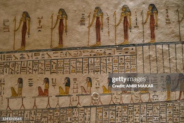 This picture taken on January 18, 2022 shows Greek graffiti inscribed by visitors from antiquity alongside the original hieroglyphic Egyptian writing...