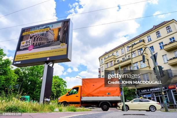 Digital billboard displays an ad for the so-called "9-euro-ticket" in Berlin on May 31, 2022. - The "9-euro-ticket", a flat rate monthly subscription...