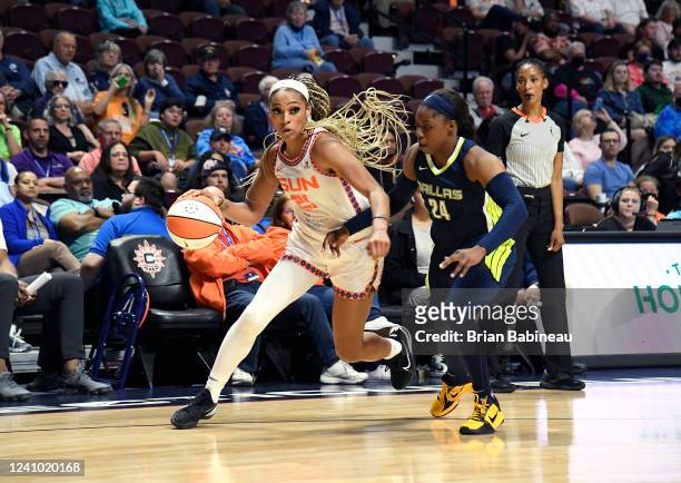 DiJonai Carrington of the Connecticut Sun moves the ball against the Dallas Wings on May 26, 2022 at Mohegan Sun Arena in Uncasville, Connecticut....