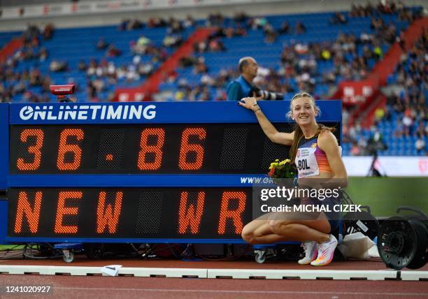 Netherlands' Femke Bol poses next to the display board with her new world record after the Women 300m Hurdles event at the IAAF 2022 Golden Spike...