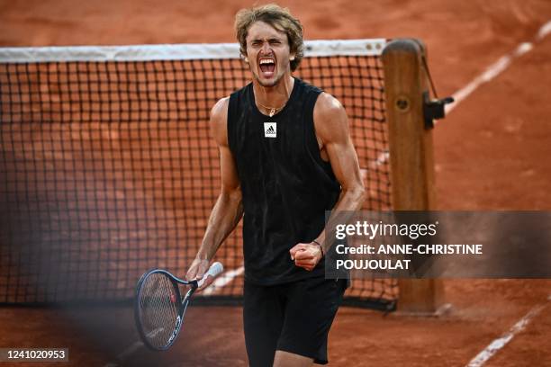 Germany's Alexander Zverev celebrates after winning against Spain's Carlos Alcaraz at the end of their men's quarter-final singles match on day ten...