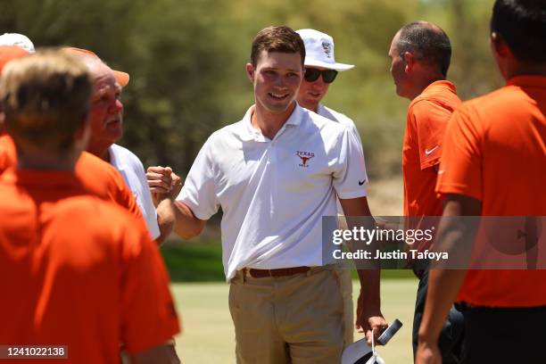 Mason Nome of the Texas Longhorns celebrates winning his match against the Oklahoma State Cowboys to advance to the semifinals of team matchplay...