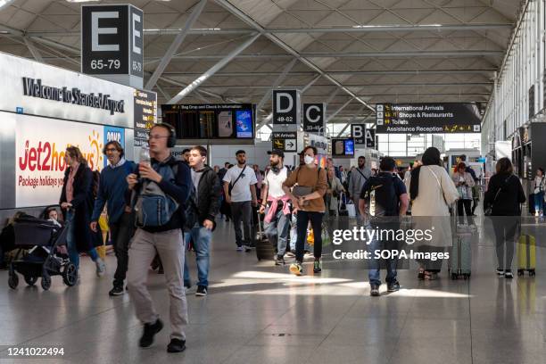 Travelers seen arriving at the Stansted Airport.