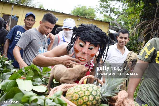 Faithful dressed as a fictional traditional character gestures during the celebration of "Las Palancas de Santa Maria Ostuma" on May 31, 2022 in La...