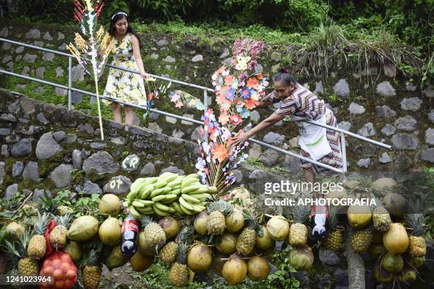 Faithfuls prepare fruits to be used during the celebration of "Las Palancas de Santa Maria Ostuma" on May 31, 2022 in La Paz, El Salvador. Locals...