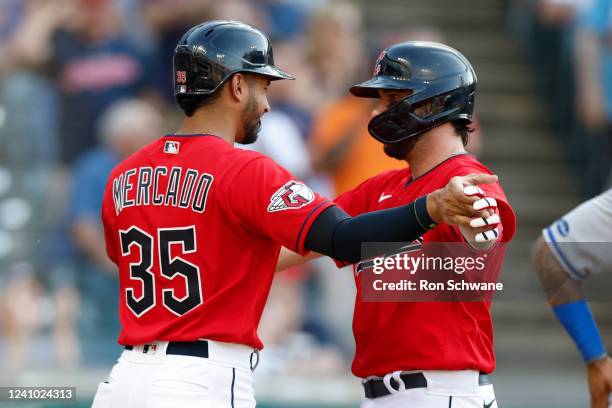 Austin Hedges of the Cleveland Guardians celebrates with Oscar Mercado after Hedges hit a three-run home run off Daniel Lynch of the Kansas City...