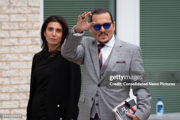 Johnny Depp waves to his fans as he walks outside court during the Johnny Depp and Amber Heard civil trial at Fairfax County Circuit Court on May 26,...