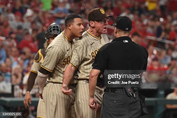 Manny Machado and manager Bob Melvin of the San Diego Padres argue with umpire Chris Conroy during the sixth inning against the St. Louis Cardinals...