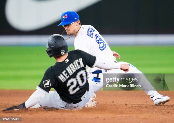 Cavan Biggio of the Toronto Blue Jays tags out Danny Mendick of the Chicago White Sox for a double play to end the in the fifth inning after Lourdes...