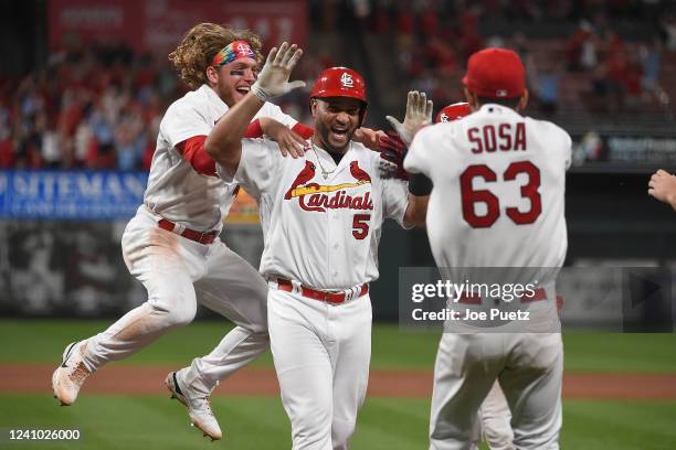 Albert Pujols of the St. Louis Cardinals is congratulated by teammates after hitting a walk-off sacrifice fly against the San Diego Padres at Busch...