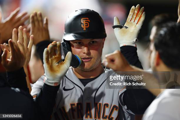Joc Pederson of the San Francisco Giants in congratulated after he hit a two-run home run against the Philadelphia Phillies during the 11th inning of...