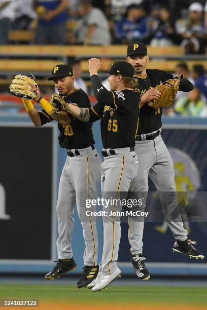 Tucupita Marcano of the Pittsburgh Pirates Jack Suwinski and Bryan Reynolds celebrate a 5-3 win over the Los Angeles Dodgers at Dodger Stadium on May...